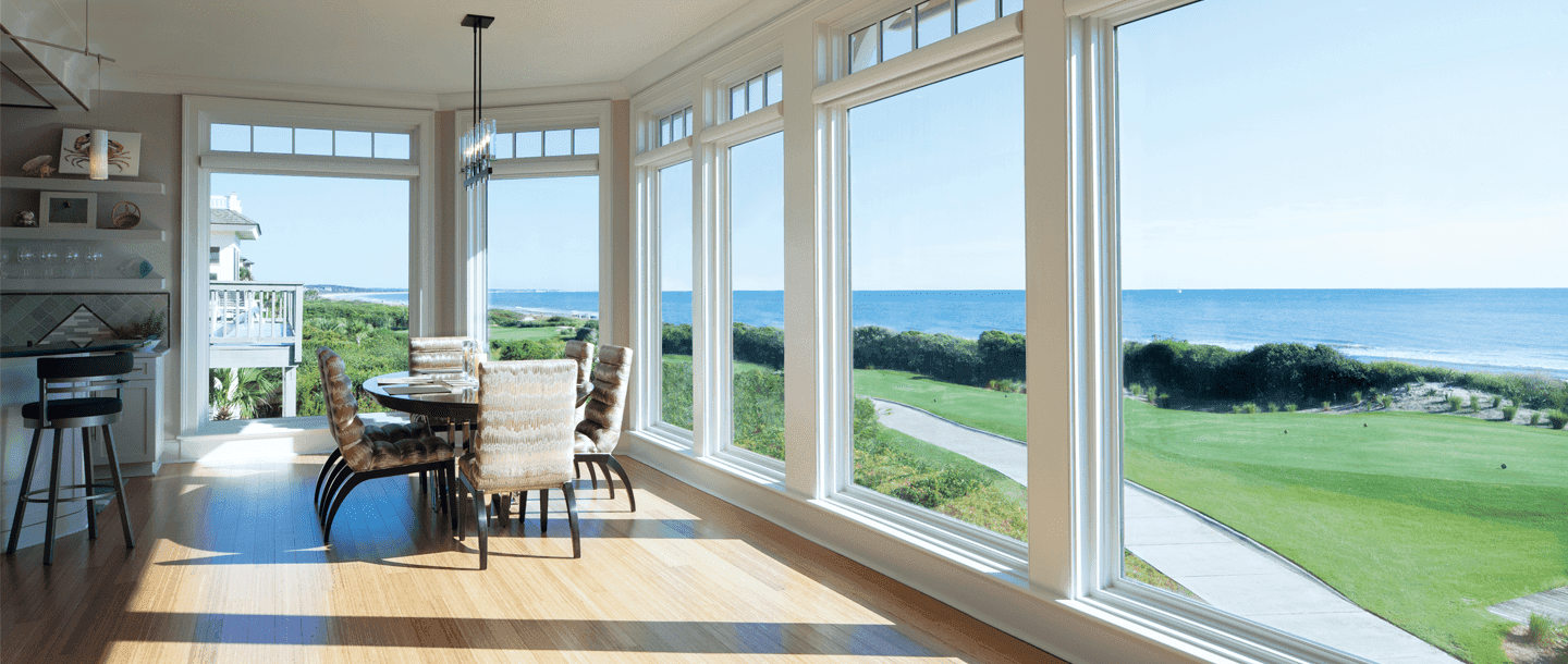A wall of vinyl picture windows looks out over a golf course.